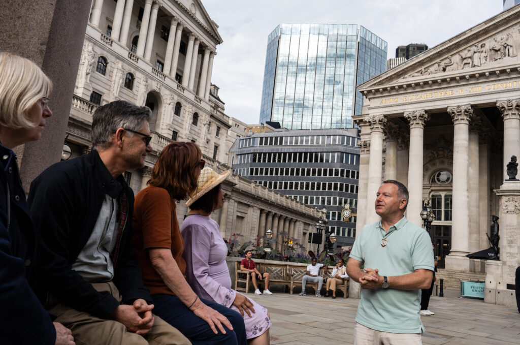 City of London Daily Guided Walks - a man giving a tour to a group of people outside Bank Station