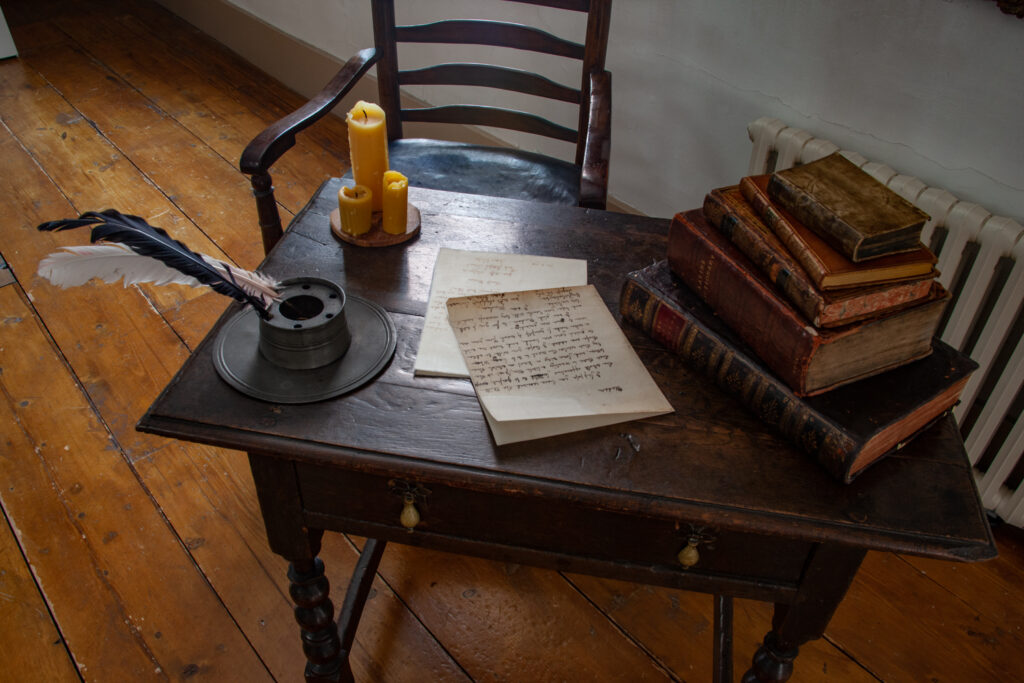 Dr Johnson's House - an old desk and chair with a quill and candle