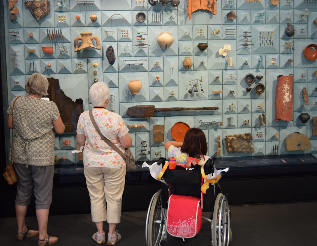 Roman London Family Quest - roman wall - ancient objects - ceramics and tools - hung across a display wall