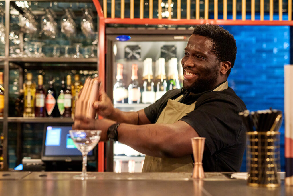 The Saint, Bow Lane - barman making a cocktailsmiling
