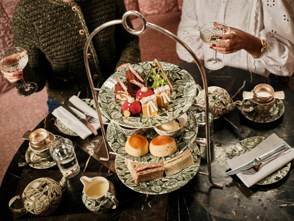 A three floor tray with sandwiches, scones and Christmas inspired cakes