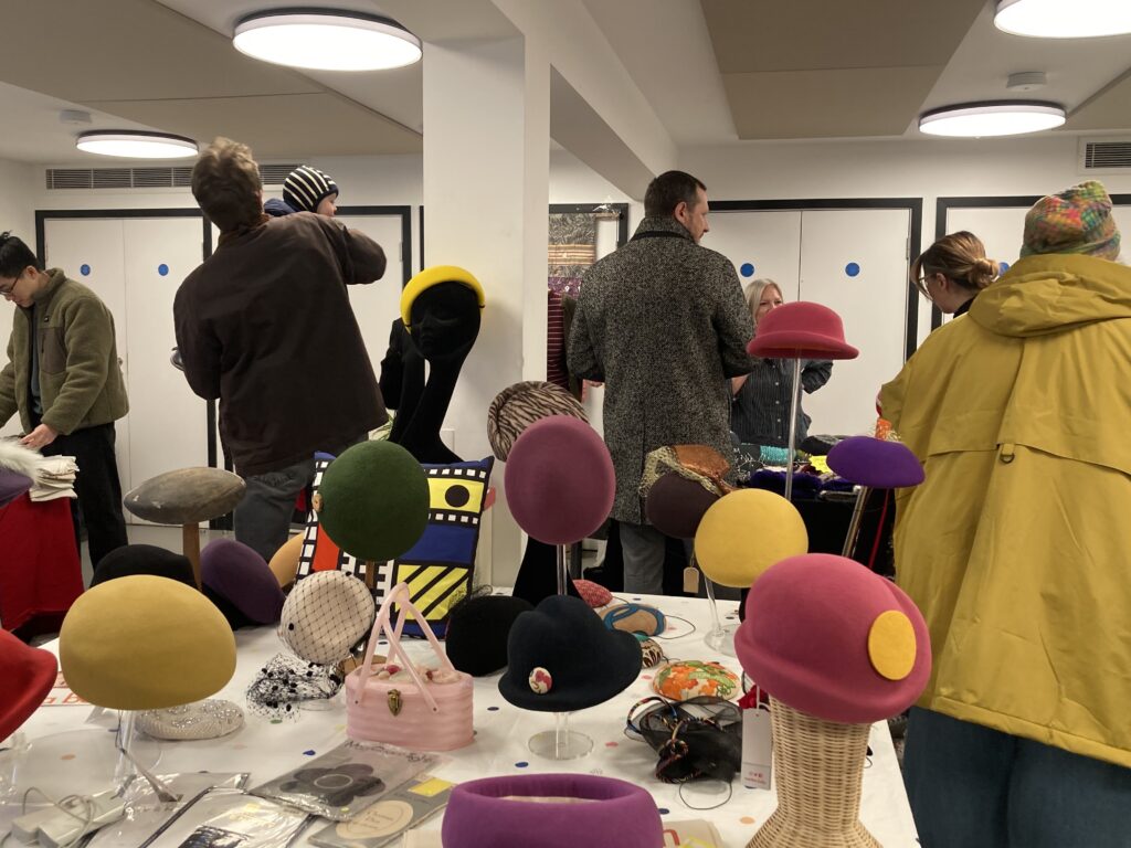 Table full of hats of different colours and sizes