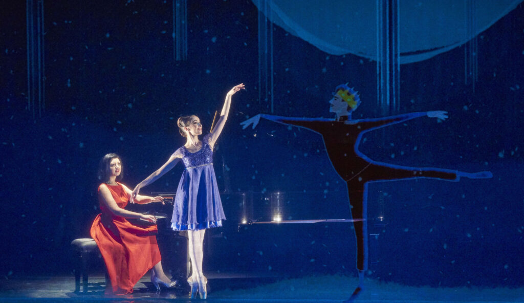 A ballerina and a pianist on a dimly lit stage, accompanied by an animated dancer.