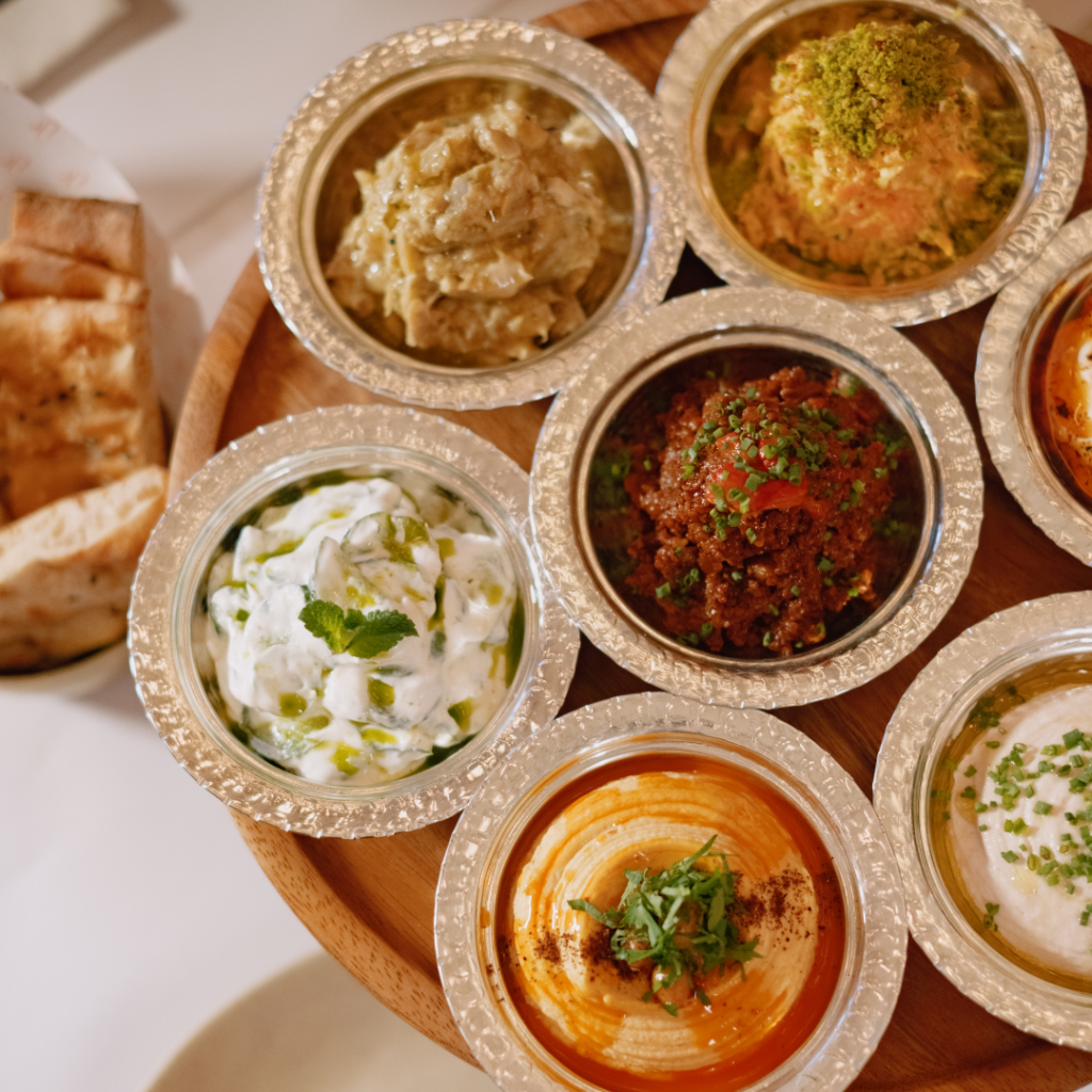 A spread of Turkish-inspired mezze with fluffy bread and a variety of dips and spreads.